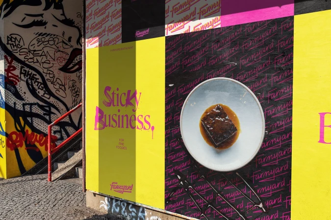 Food advertisement on an urban wall features a food plate, brand logos, text, and colorful graffiti, blending culinary promotion with street art.