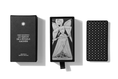 Black tarot deck box and cards with silver foil illustrations on white background