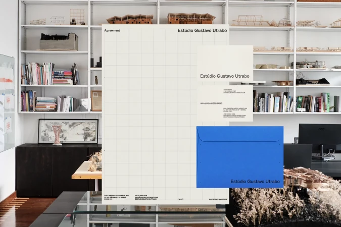 Architectural office stationery mockup featuring letterhead, business card and envelope with shelving in the background.