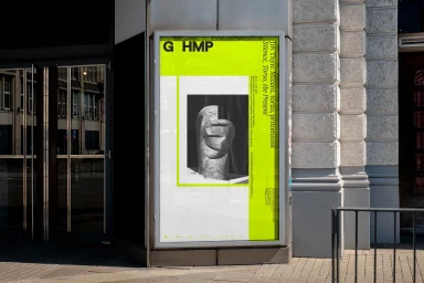 Public advertising poster for Jiří Thýn exhibition displayed on an outdoor urban kiosk with bright lime green branding