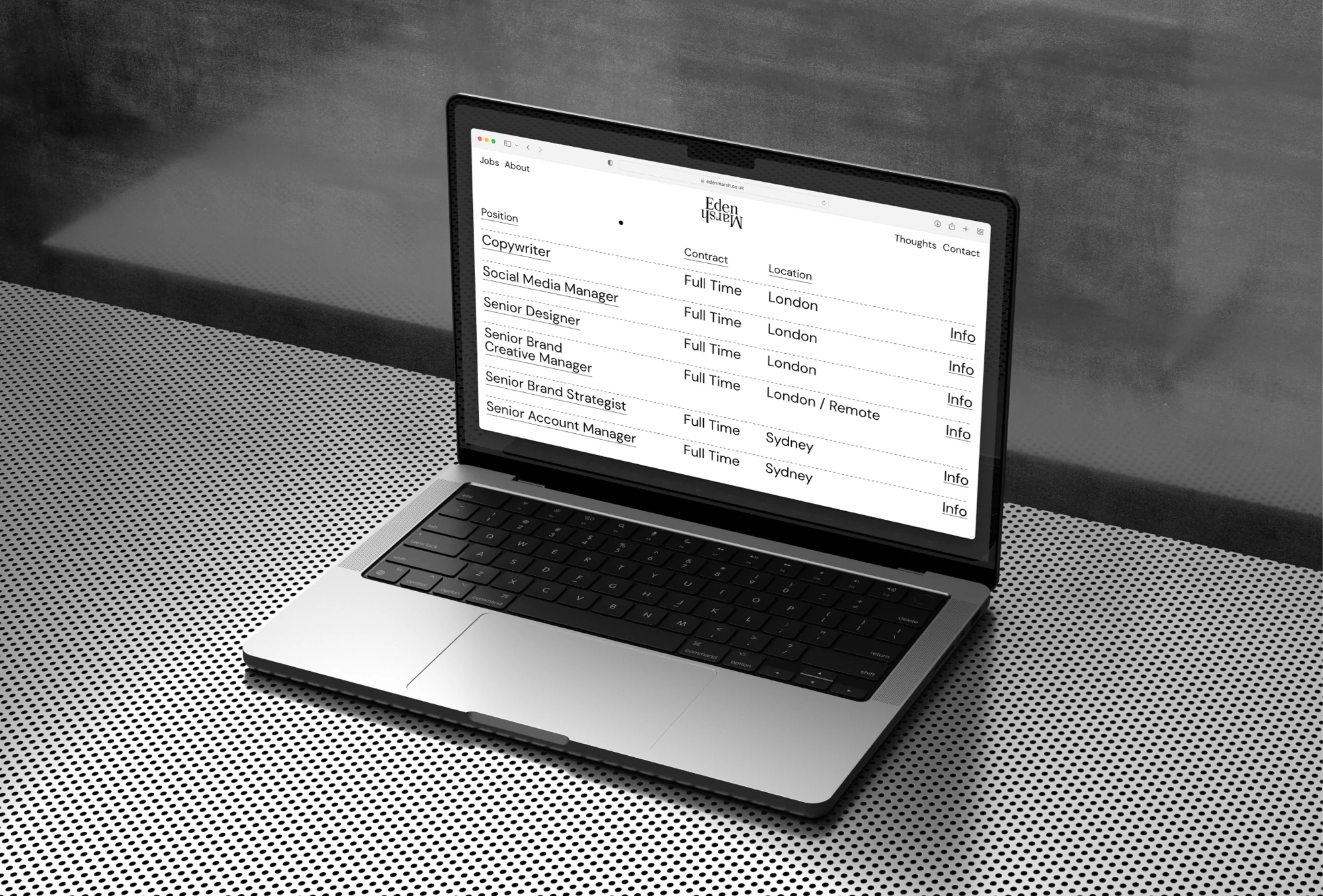 Laptop on a table showing a list of job openings at Eden Marsh, including copywriter, social media manager, designer, and brand strategist.