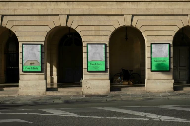 Exterior facade featuring three framed posters with green graphic accents mounted on a classical stone building with arches.