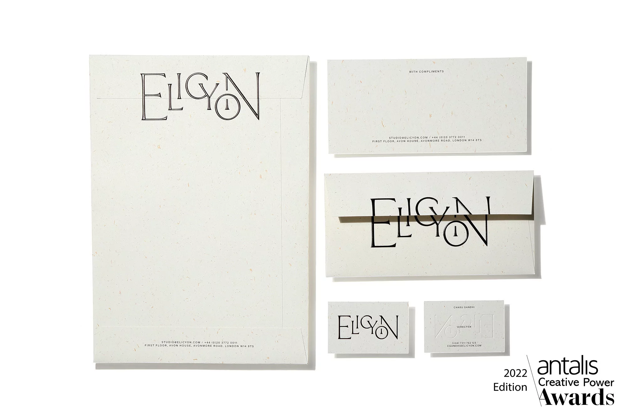Close-up of stationery items: envelope, cards, and logo featuring 'Elicyon' for branding and corporate communication design.