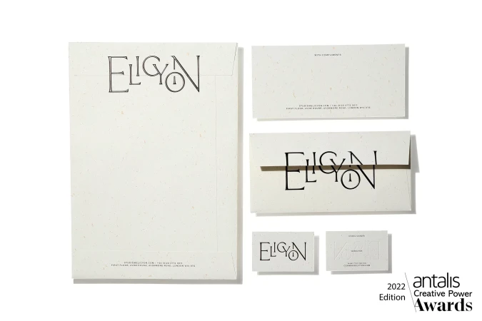 Close-up of stationery items: envelope, cards, and logo featuring 'Elicyon' for branding and corporate communication design.