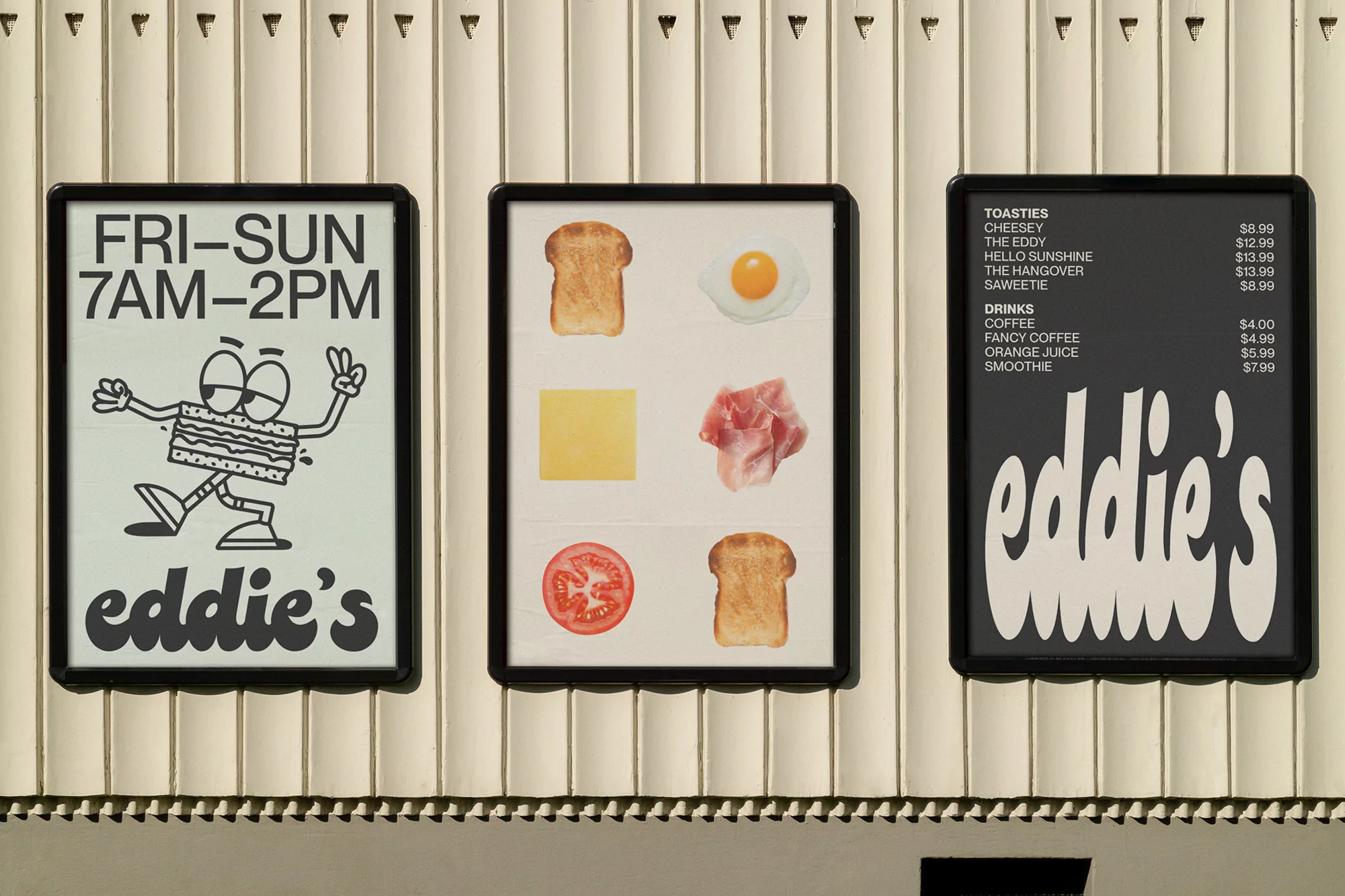 Three framed posters hang on a wall, showcasing restaurant information, menu item illustrations, and toastie/drink options with prices.