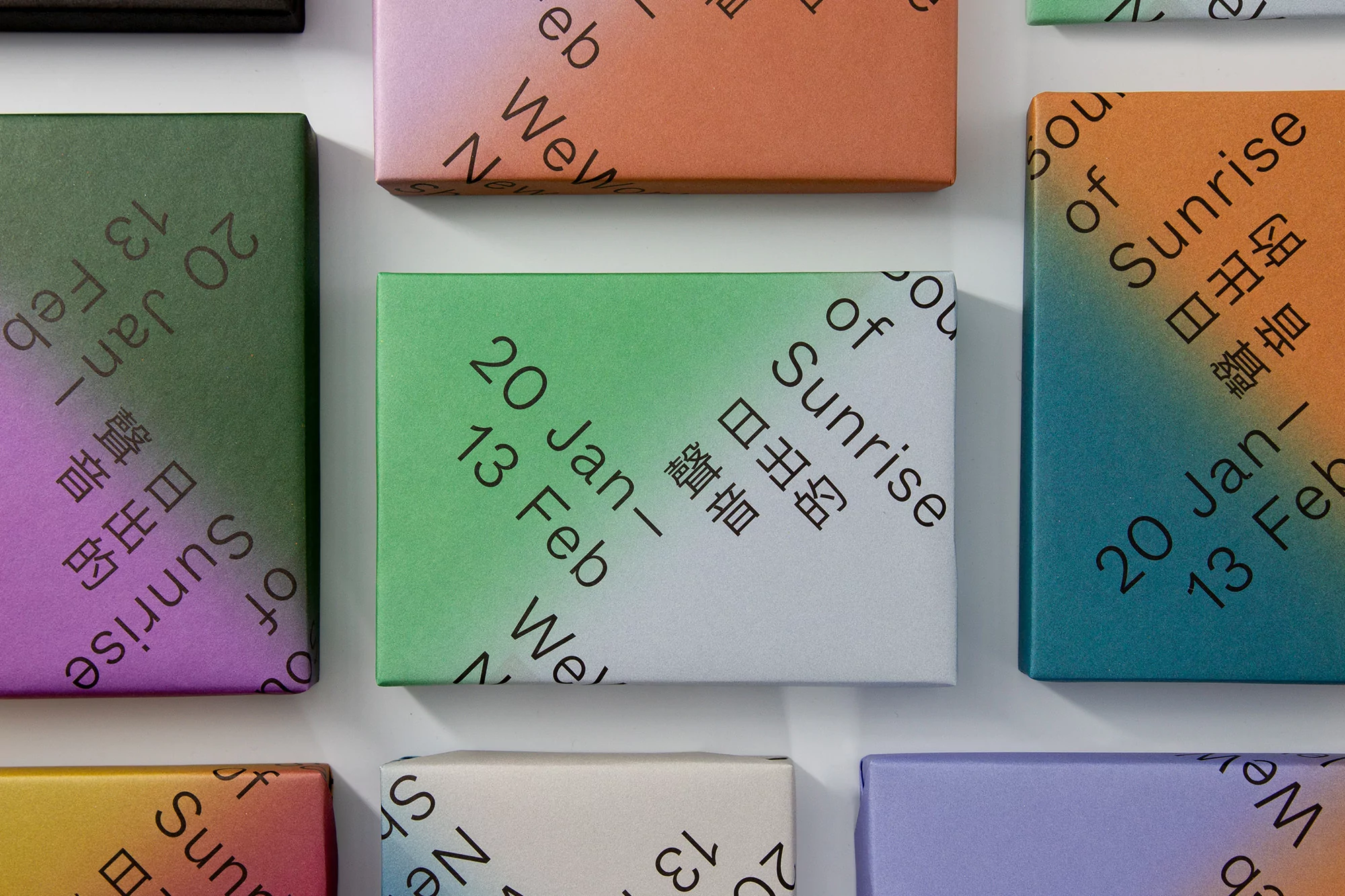 Several colorful rectangular objects are arranged in a grid pattern, each featuring dates, text, and a vibrant color gradient.
