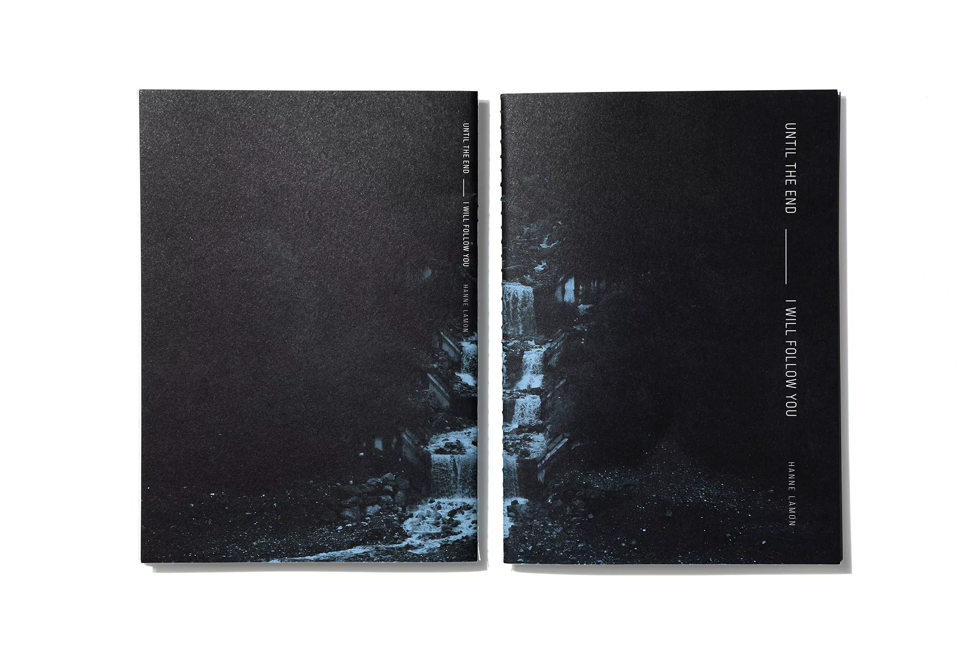 Two book covers, with dark colors and waterfall imagery, lay side-by-side on a white surface. One book features text on the cover.