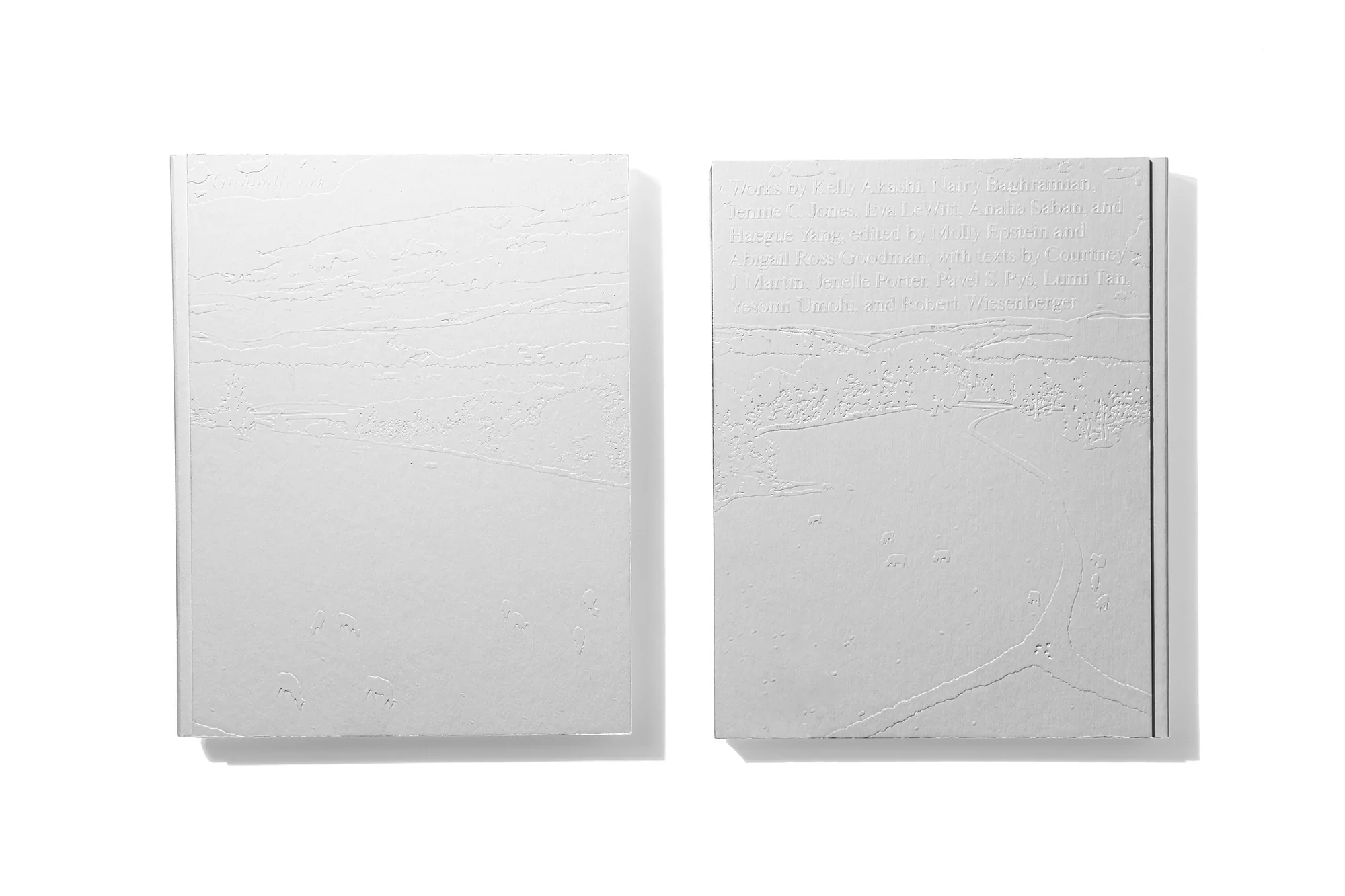 Two white book covers feature subtle embossed patterns and minimal design, emphasizing texture and a clean, modern aesthetic on white.