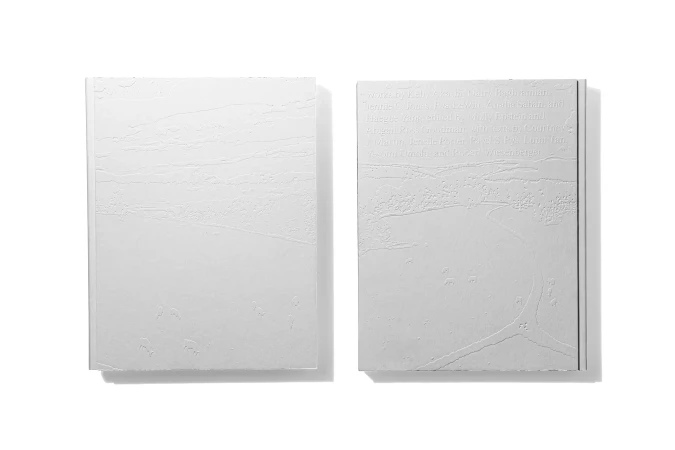 Two white book covers feature subtle embossed patterns and minimal design, emphasizing texture and a clean, modern aesthetic on white.