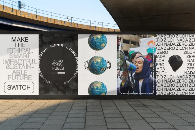 Eye-level shot of a public art installation featuring posters with climate-related slogans, a woman speaking into a megaphone, and stone.