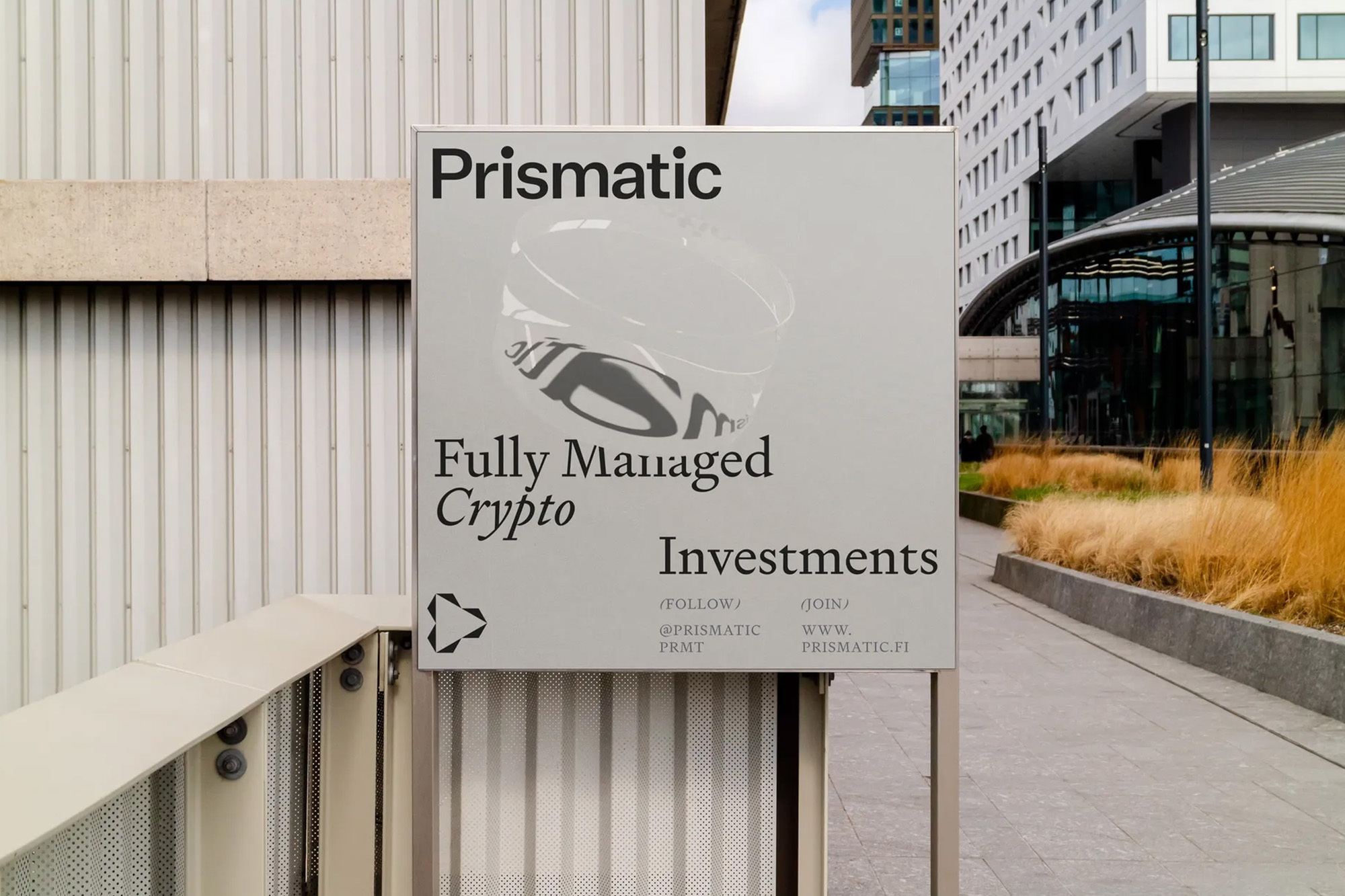 Signage featuring Prismatic, a company that offers fully managed crypto investments, positioned outdoors in a modern urban environment.