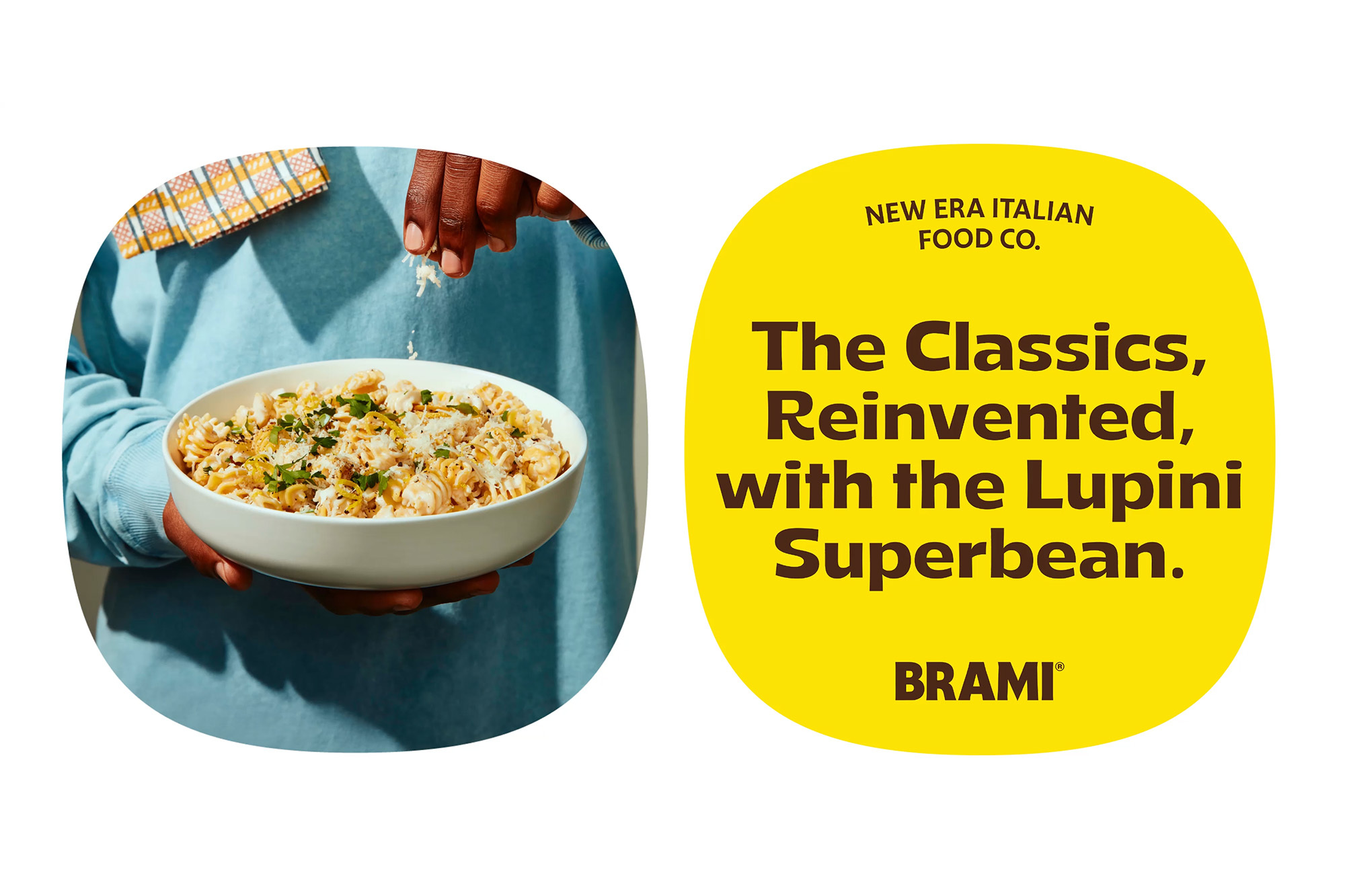 Dish of pasta is garnished with cheese by an adult's hand; brand messaging is displayed on a yellow circular graphic.