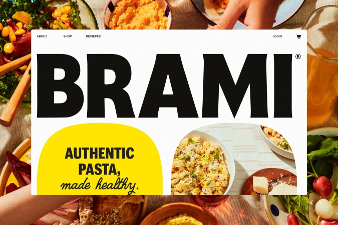 Overhead shot of a brand promotion for Brami pasta, featuring bowls of salad, pasta, and snacks, set on a sunlit table with hands reaching.