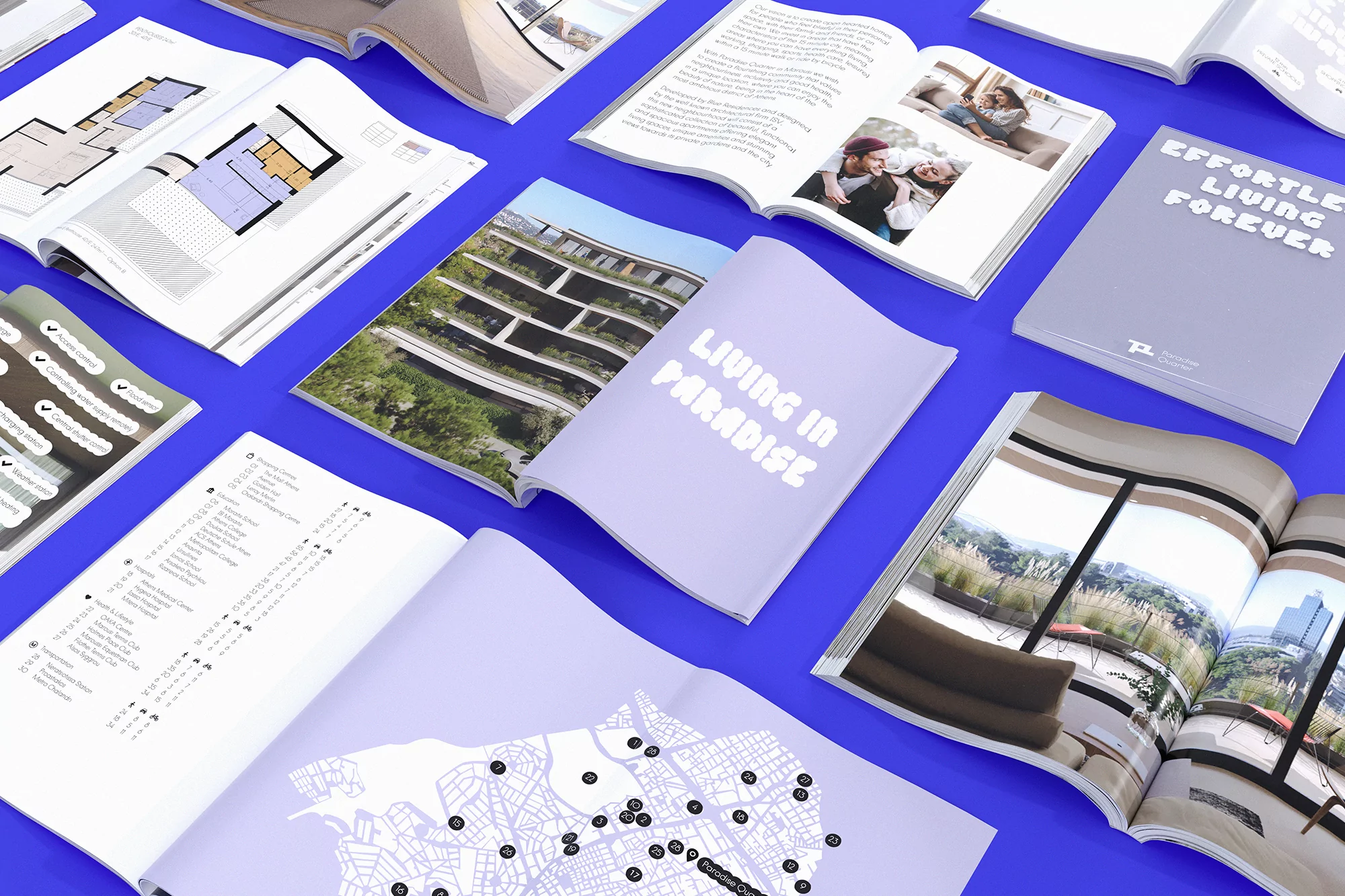 Several open lifestyle magazines with various images and graphics are neatly arranged on a vibrant blue surface, showcasing different design layouts.