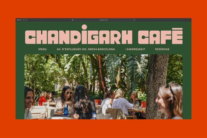 Website for Chandigarh Cafe showing outdoor restaurant seating with group of women dining beneath trees on sunny day in Barcelona, Spain.
