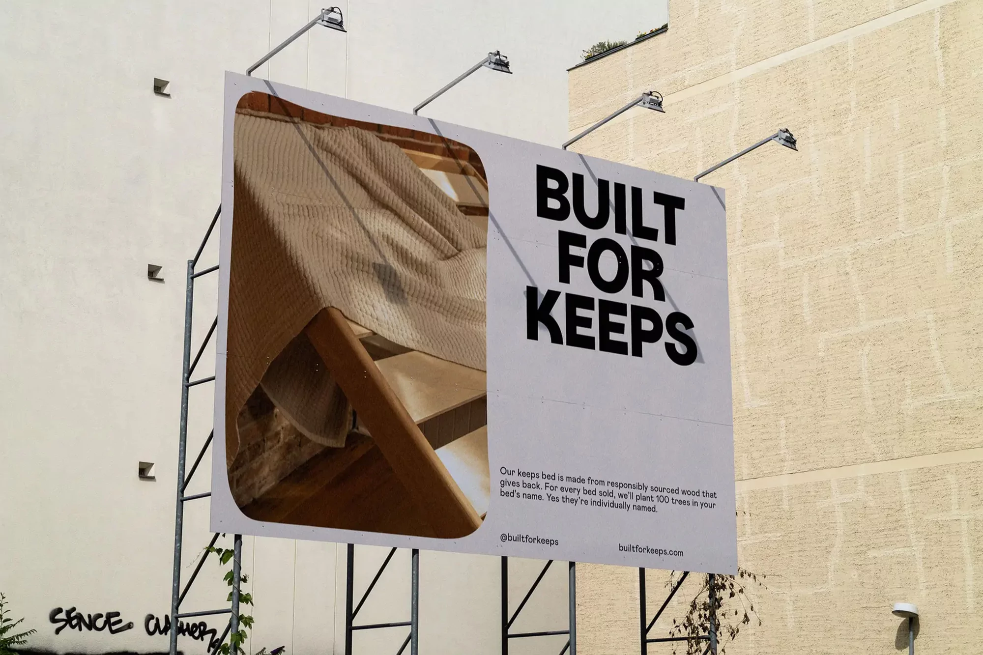 Billboard displaying an advertisement for 'Built for Keeps' featuring a draped bed and typography on a building facade in daylight.