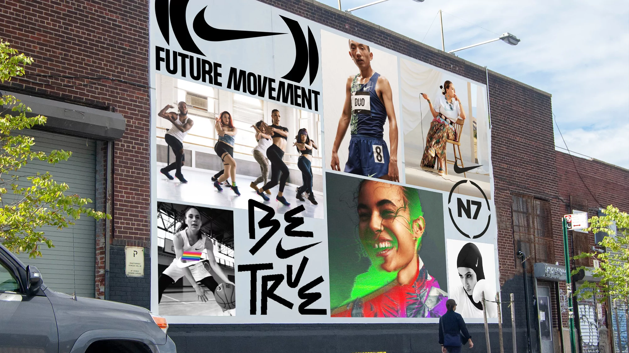 Exterior shot of a large Nike billboard on a brick building featuring several athletic people and the text 'Future Movement, Be True'.