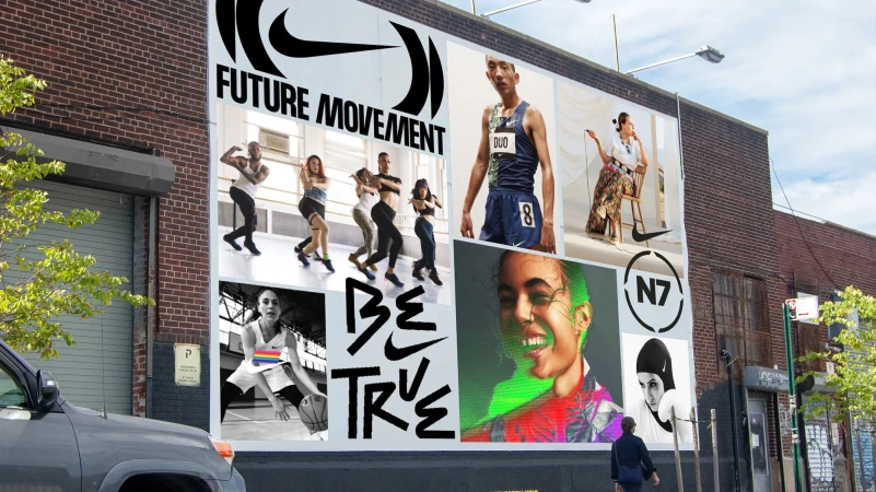 Exterior shot of a large Nike billboard on a brick building featuring several athletic people and the text 'Future Movement, Be True'.