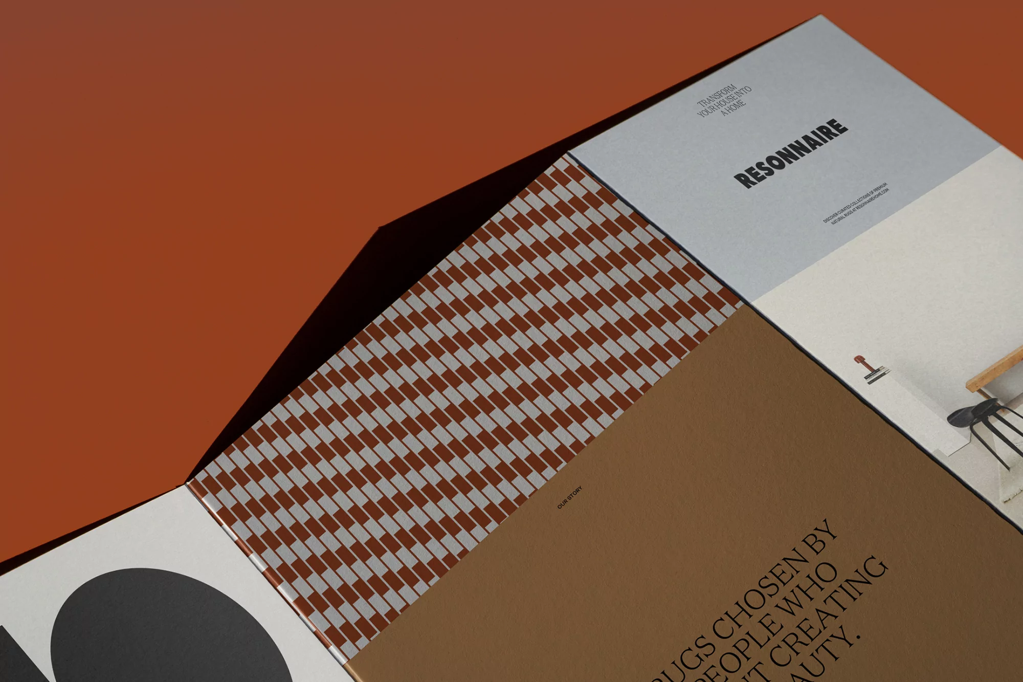 Stack of graphic design books in earth tones against a burnt orange background featuring a geometric patterned cover.