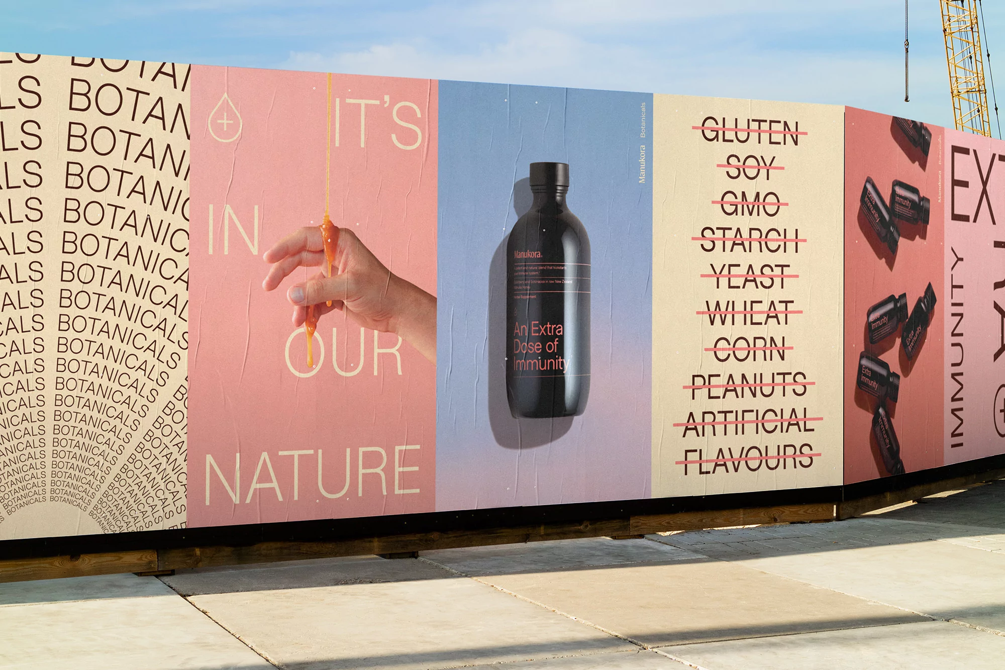 Outdoor posters promote a black bottle and feature food ingredient exclusions. A hand holds an orange liquid with the words 'It's in our nature'.