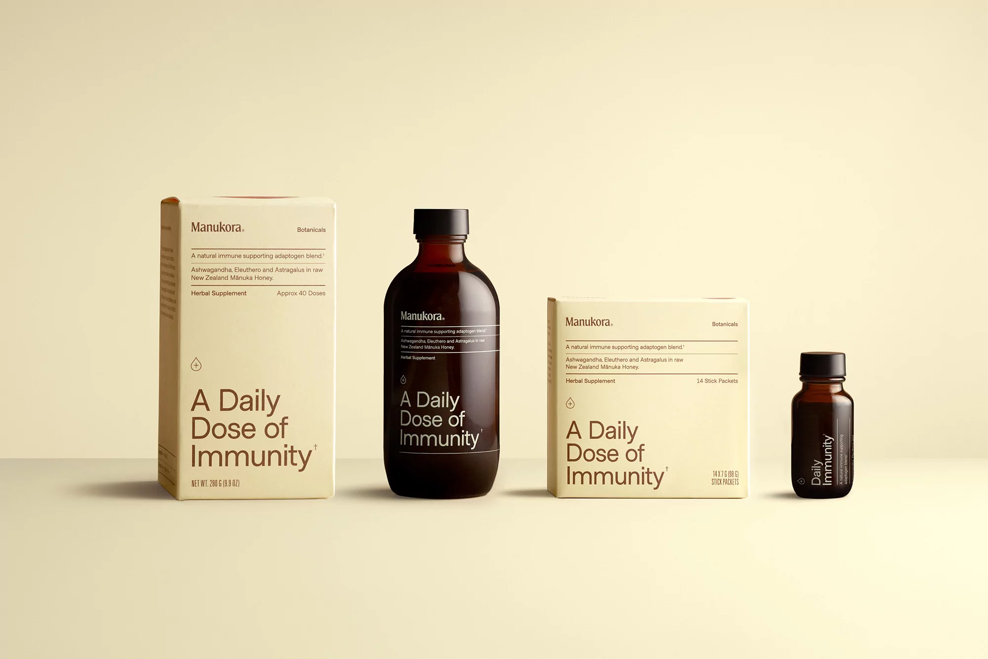 Manukora immunity supplement product lineup. Includes box and bottle formats in a neutral color palette against a light background.