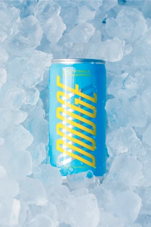 Eye-level shot of a blue beverage can surrounded by crushed ice, creating a cool and refreshing visual for the product advertisement.