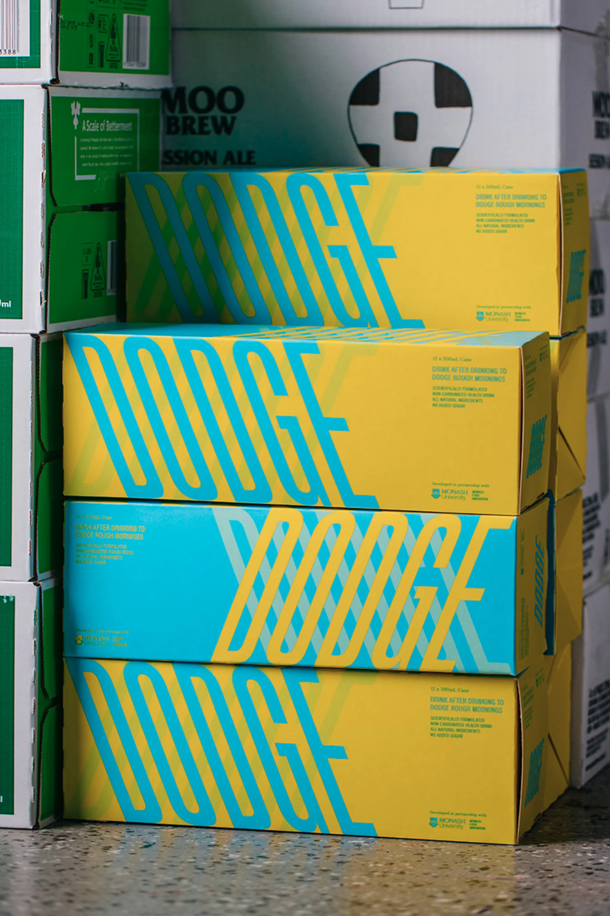 Stacked boxes of DOCE Session Ale, featuring a modern yellow and blue design, arranged in a warehouse or storage setting.
