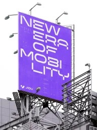 Large purple billboard with white typography reading New Era of Mobility mounted on a metal structural frame against an overcast sky