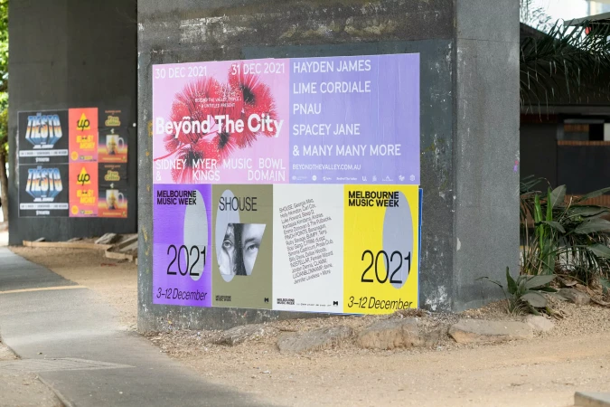 Outdoor view of Melbourne Music Week and Beyond The City promotional posters affixed to a concrete pillar, advertising the 2021 event.