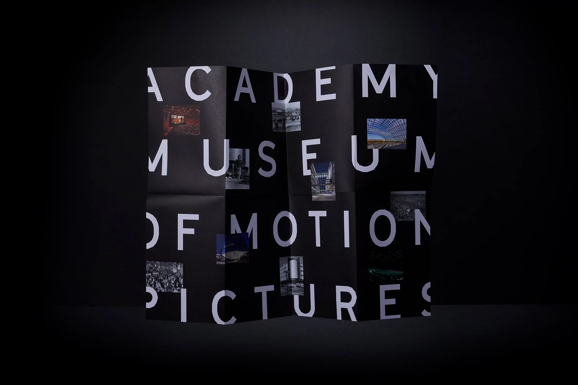 Academy Museum of Motion Pictures promotional material featuring collaged imagery and bold typography on a folded black paper surface.