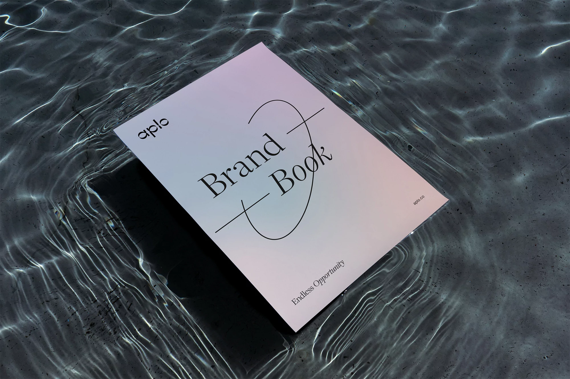 A brand book floats on a textured surface with shimmering water reflections, featuring the brand name 'aplo' and the phrase 'Endless Opportunity'.