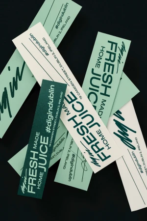 Scattered labels with 'Fresh Juice' and social media handles in light green on cream and dark green on black background.