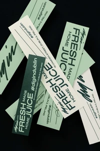 Scattered paper labels and receipts featuring typography and branding for DIG IN Art Diner on a dark background