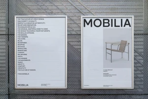 Two framed minimalist posters featuring the Mobilia brand and typography mounted on a perforated metal wall