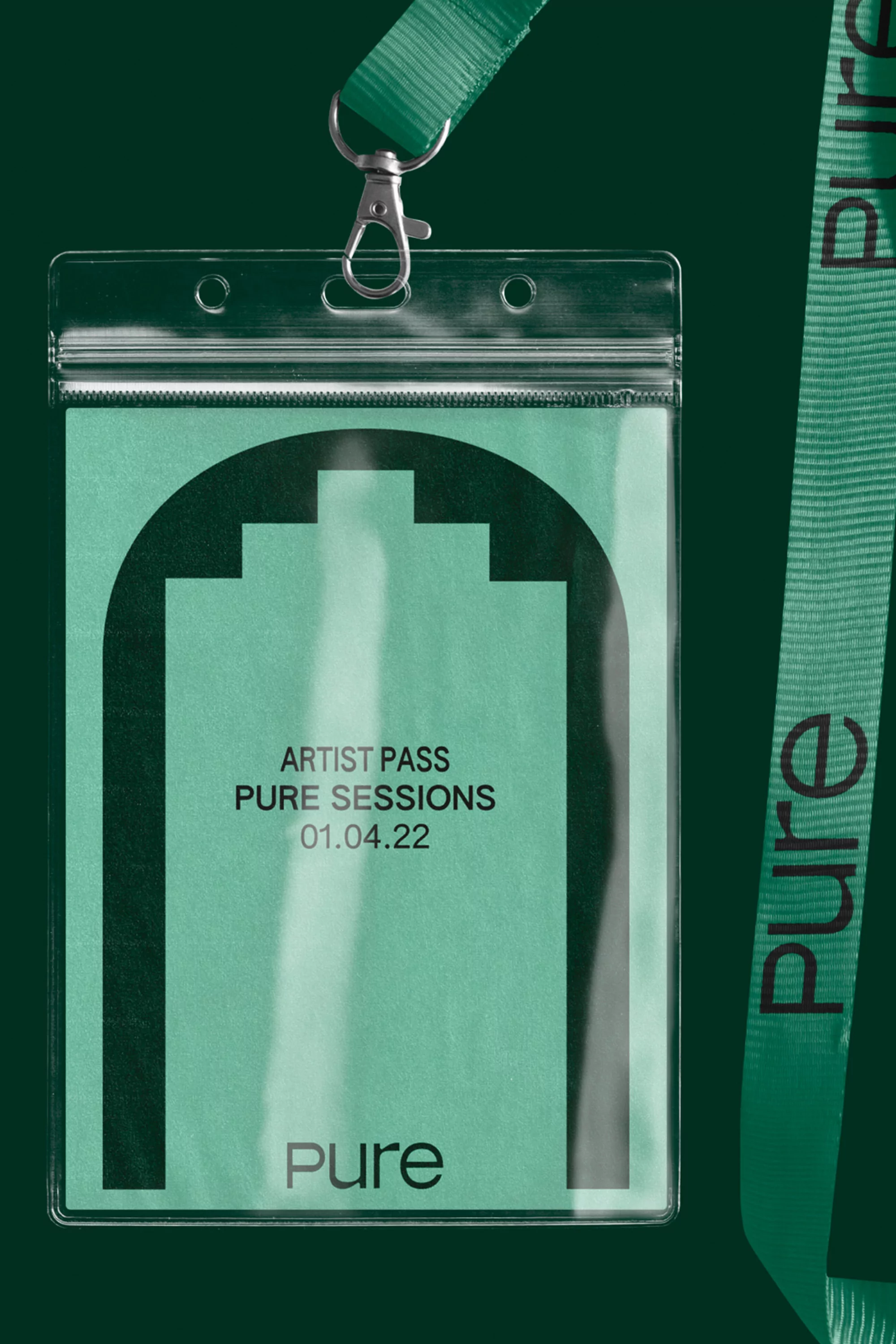 Green and clear plastic artist pass for Pure Sessions event on a lanyard with a modern graphic and Pure logo on a dark green backdrop.