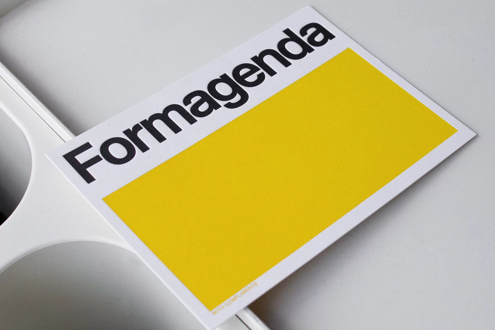 Formagenda brand advertisement, featuring a bright yellow rectangle and bold black font on a white card against a white background.