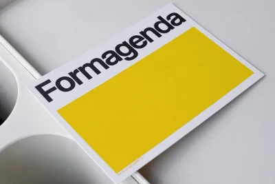 Formagenda brand identity card with black typography and yellow block resting on white surface
