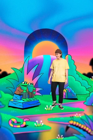 Person stands near frog statues in colorful cartoon landscape. A woman in black pants and a yellow tee shirt smiles in a surreal environment.