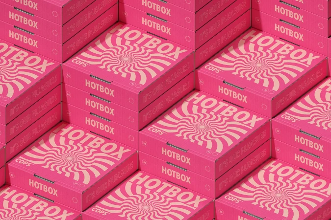 Stacks of vibrant pink Hotbox food delivery containers featuring swirling graphic and typography in a repeating isometric pattern.