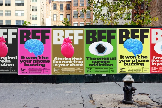 Urban posters promoting the Brklyn Film Festival display vibrant images of brains, hearts, and eyes, with the city visible in the background.