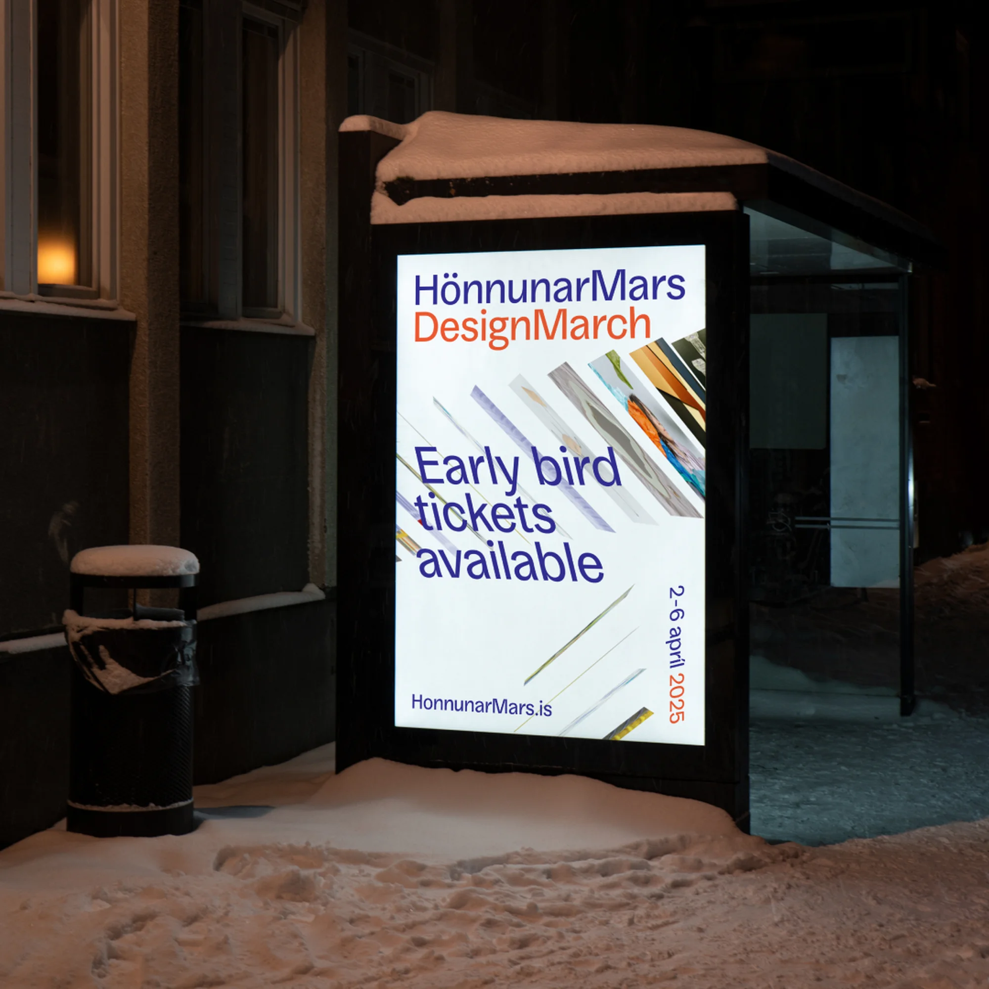 Illuminated advertising poster featuring 'HönnunarMars DesignMarch' visible at a bus stop in a snow-covered urban setting at night.