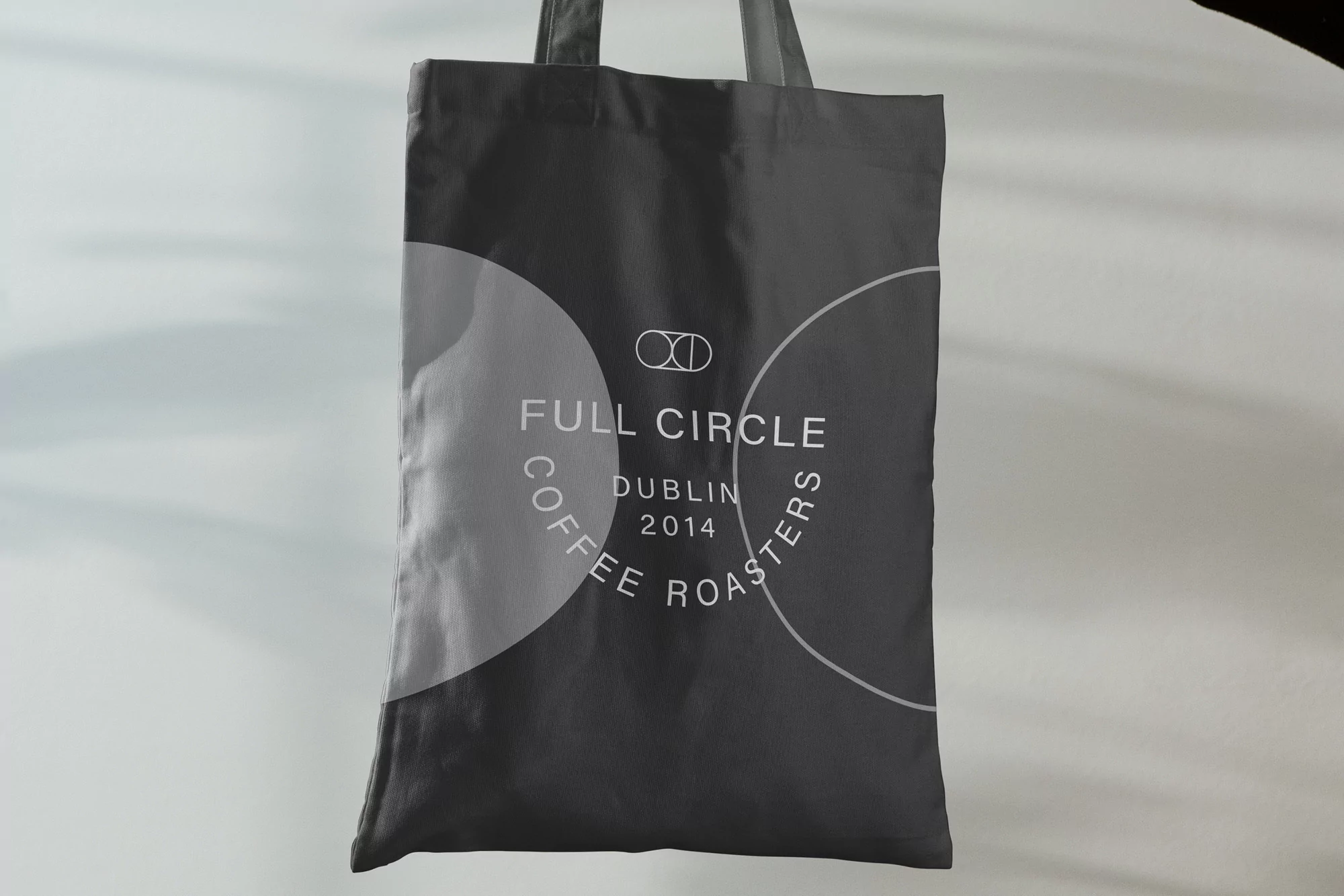 Gray tote bag featuring 'Full Circle Coffee Roasters Dublin 2014' logo, clean studio lighting, and minimalist composition.