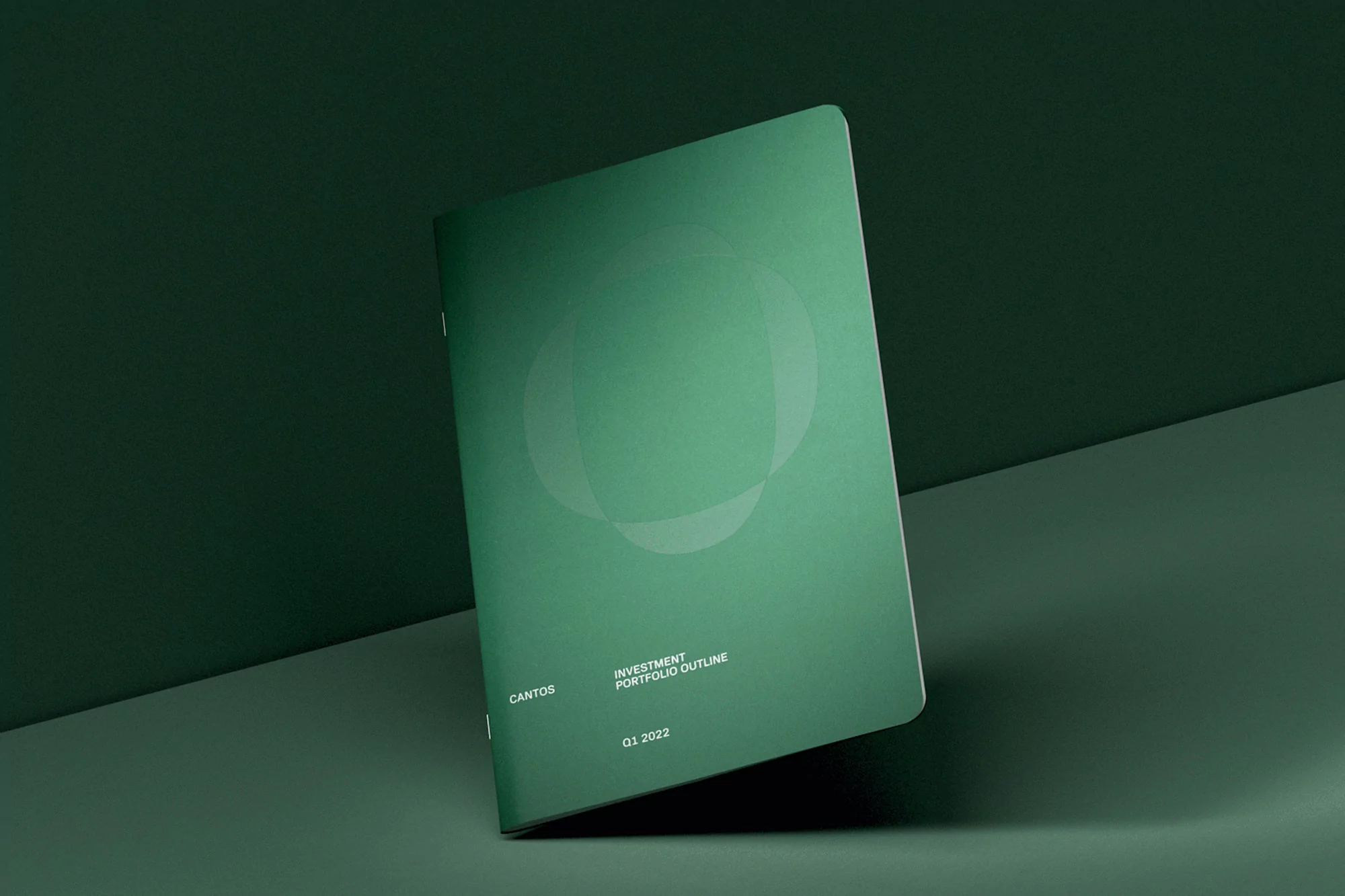 Green booklet cover featuring a geometric logo, titled 'Cantos Investment Portfolio Outline Q1 2022', on a matching green surface.