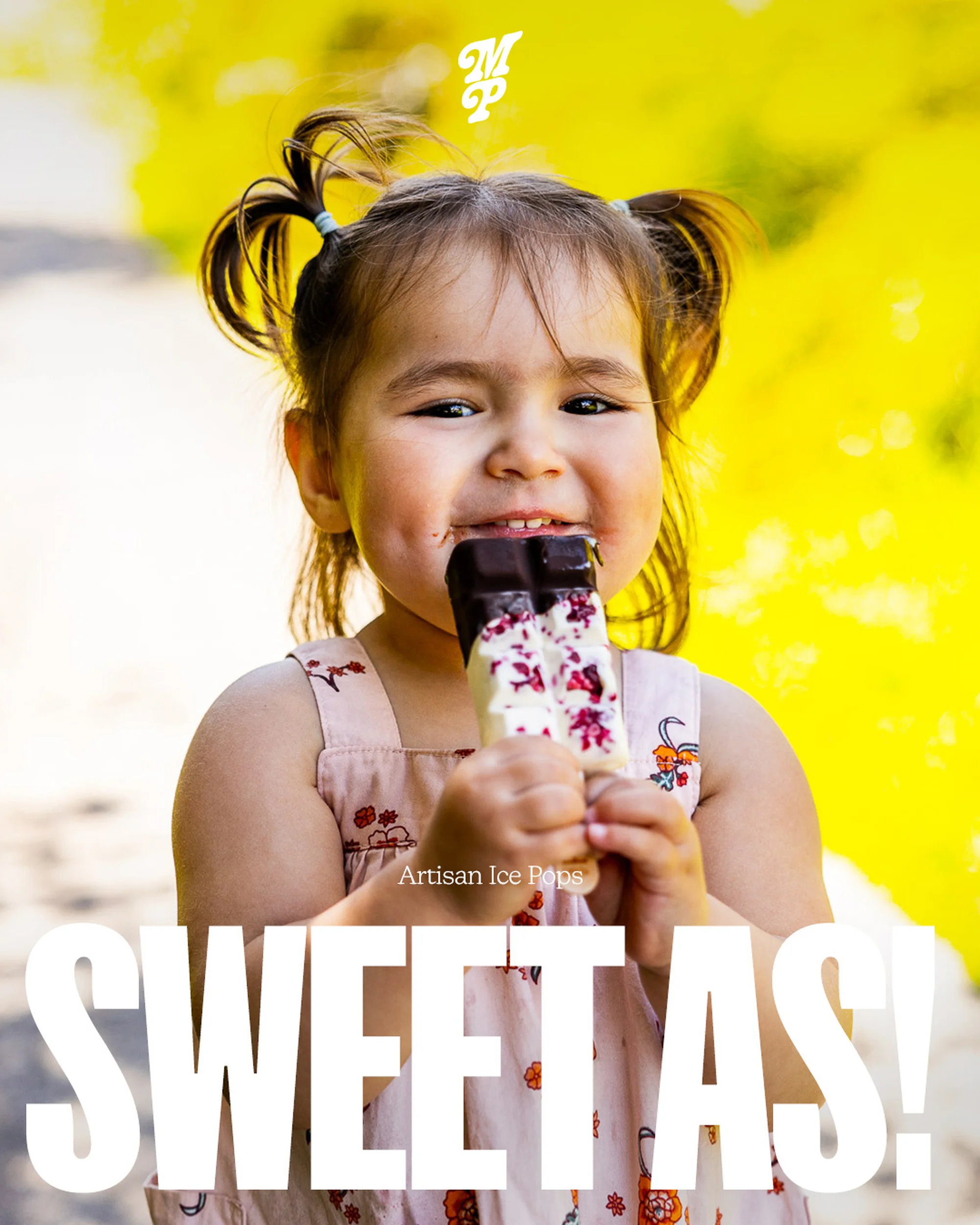 Close-up of a happy young girl enjoying an ice pop with a bright yellow background. Sweet As! is in white text overlayed on the bottom.