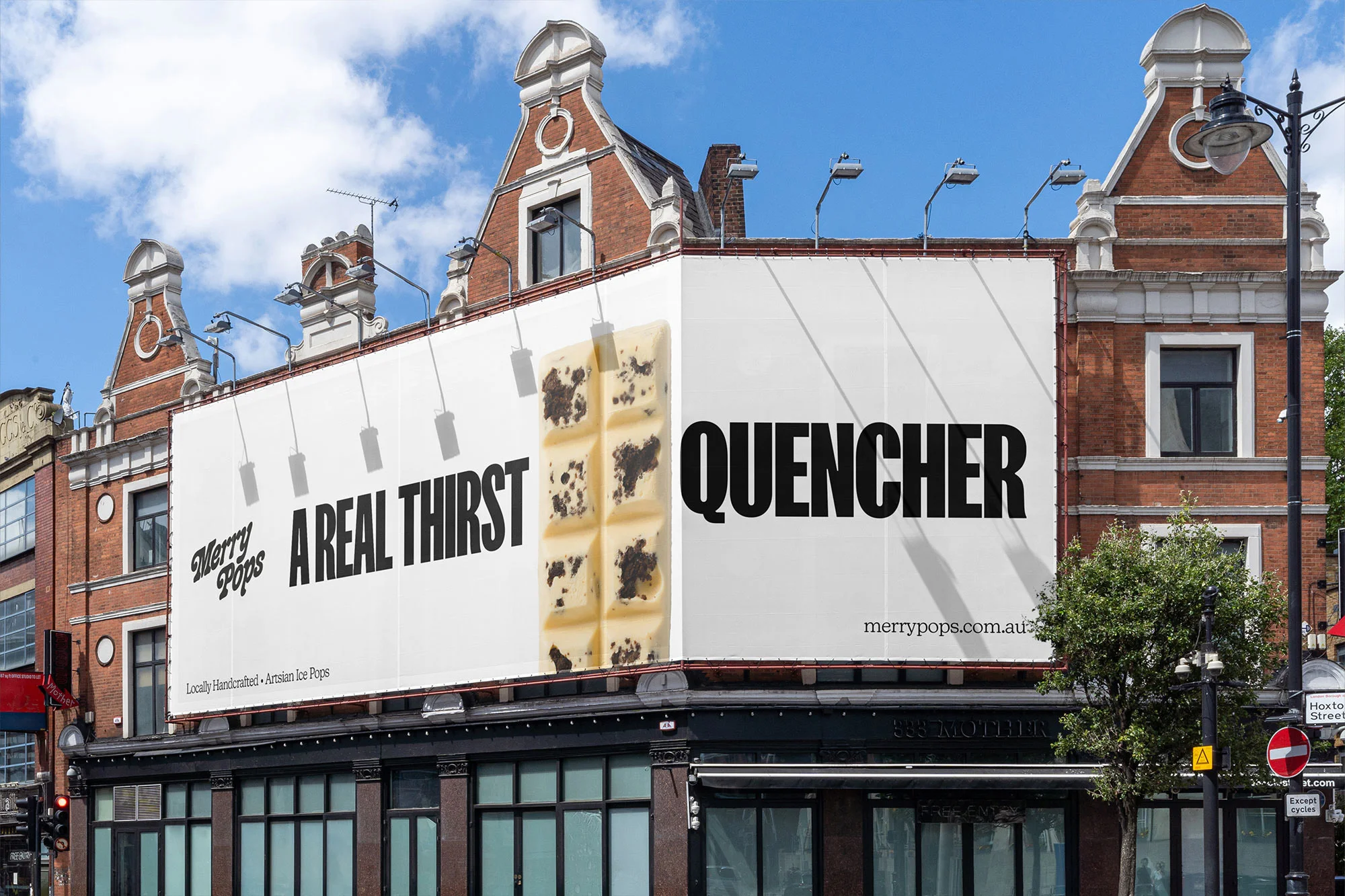 Outdoor billboard on a brick building features a product called 'Quencher' by Merry Pops, highlighting an ice cream bar and bold typography.
