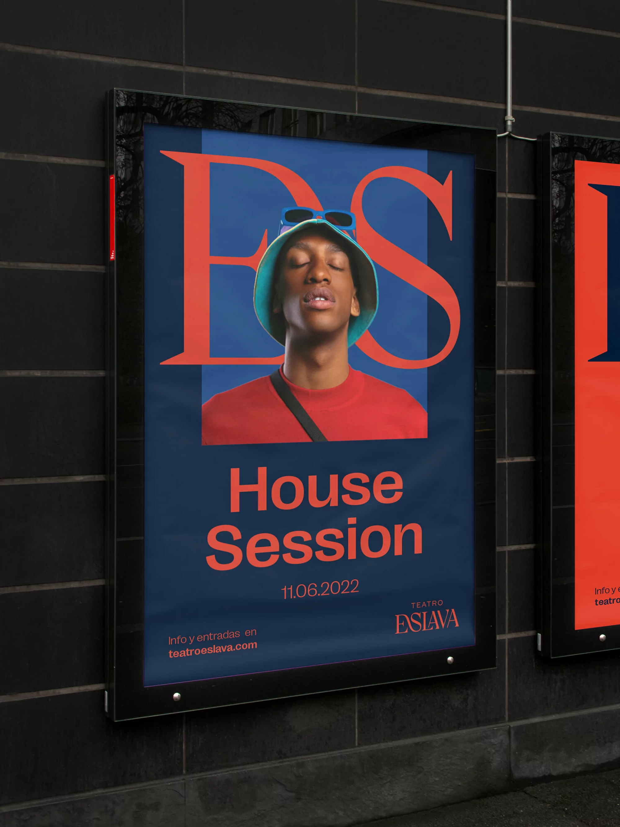 Outdoor poster for Teatro Eslava featuring a black man in a bucket hat and red shirt against a dark tiled wall.
