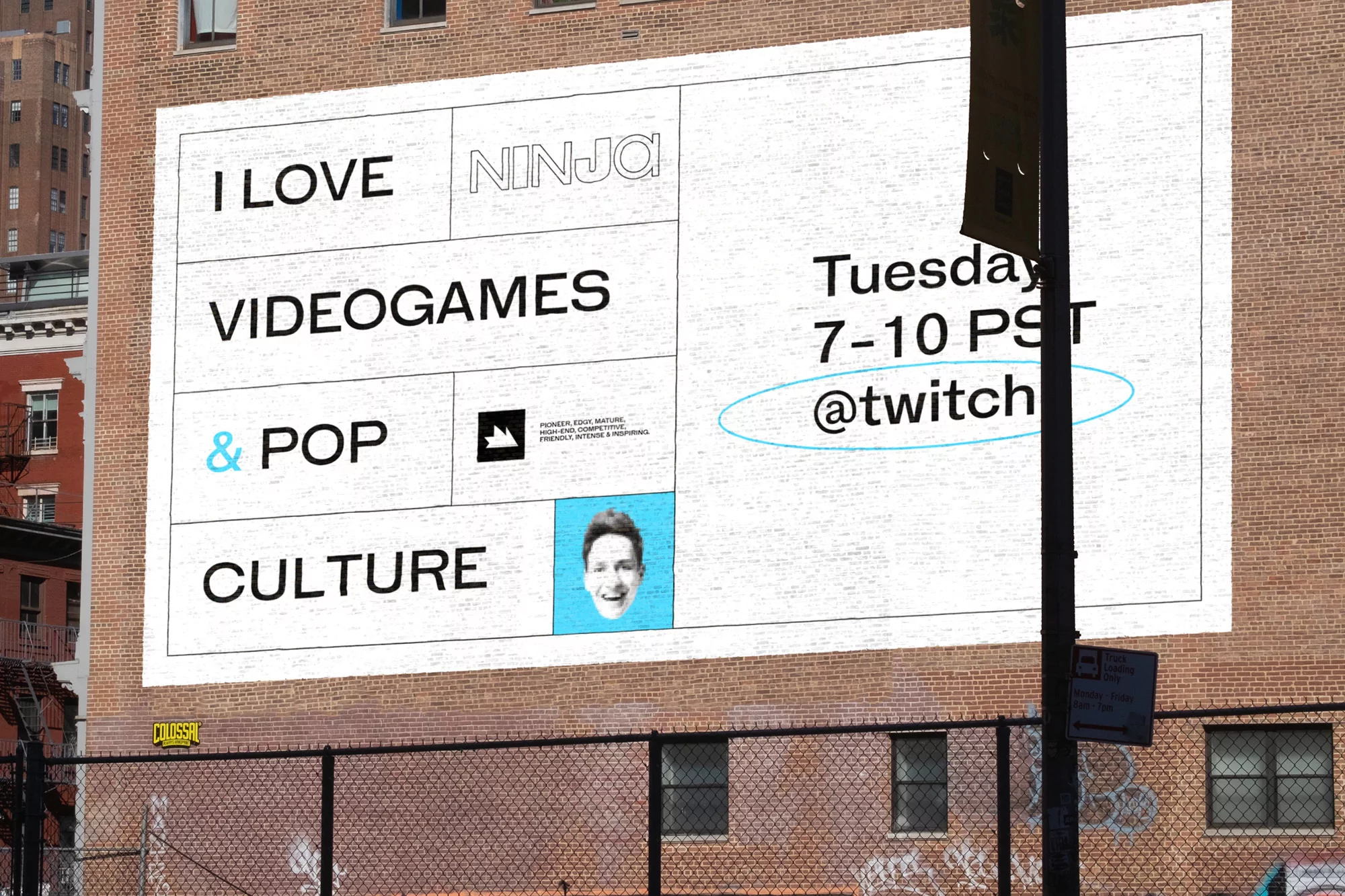 Outdoor shot of a brick wall with a large advertisement featuring text, an image of a person, and Twitch social media handle.