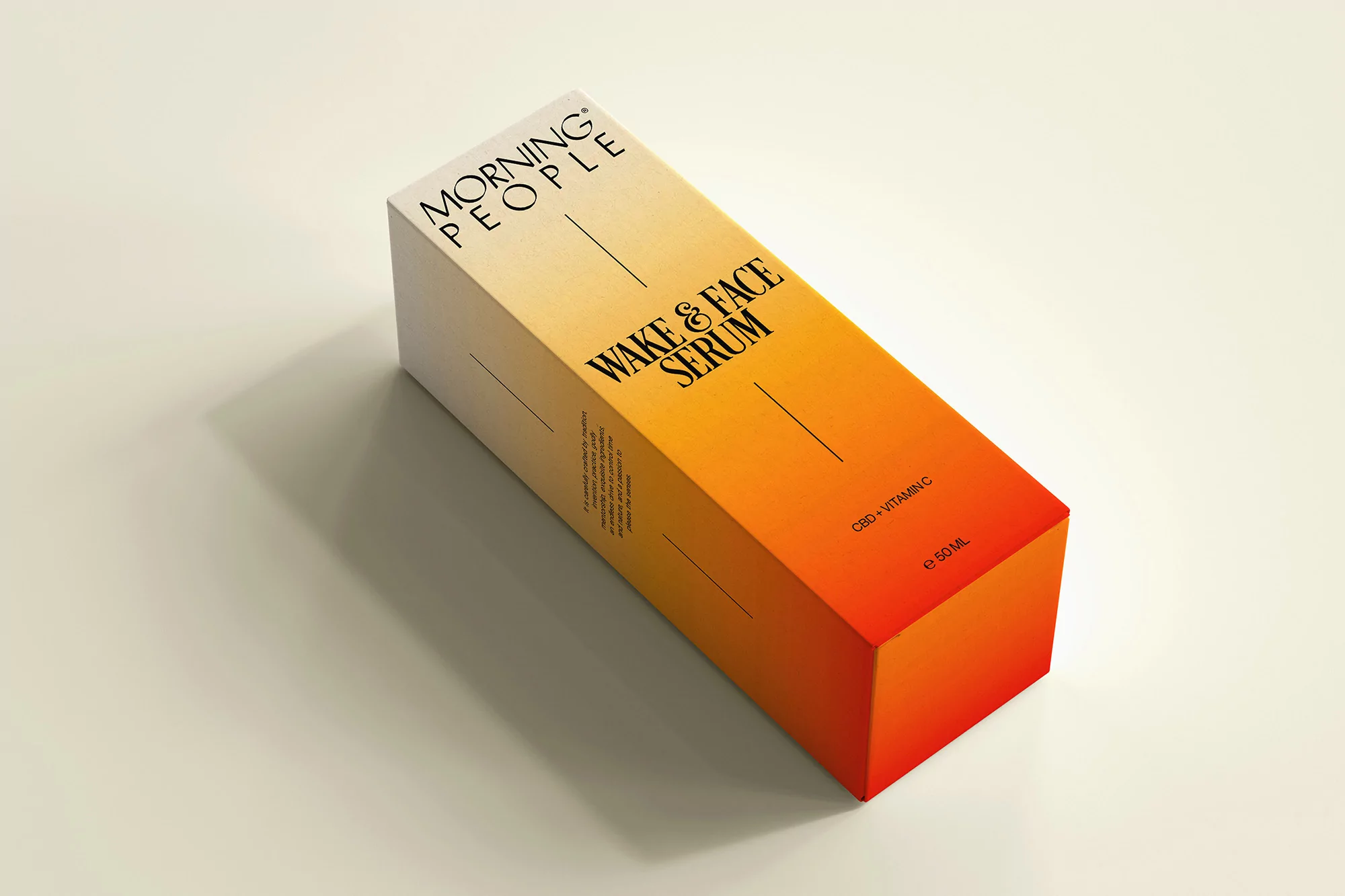 Product shot of Morning People Wake & Face Serum box with yellow to orange gradient. Cosmetic serum box on cream-colored surface.