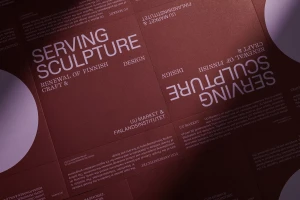 Close-up overhead view of dark burgundy printed paper layout with white sans-serif typography and white circular shapes