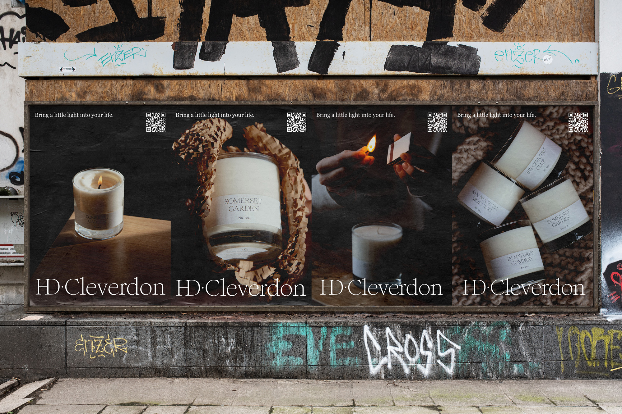 Billboard in an urban setting showing an advertisement for HD Cleverdon candles, featuring lit candles and matches.